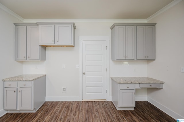 kitchen featuring dark hardwood / wood-style flooring, crown molding, and light stone countertops