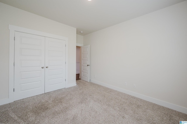 unfurnished bedroom featuring a closet and carpet