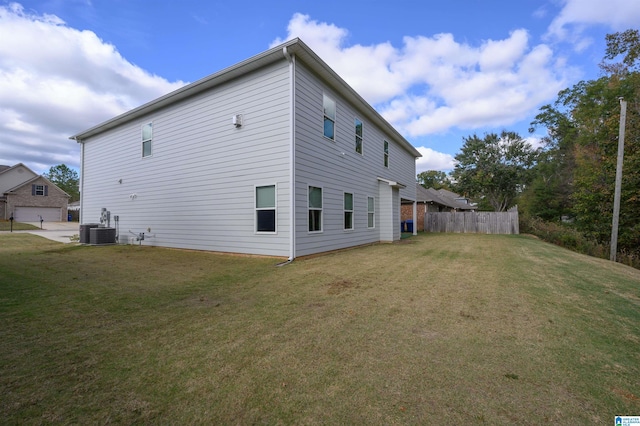 back of house featuring cooling unit and a yard