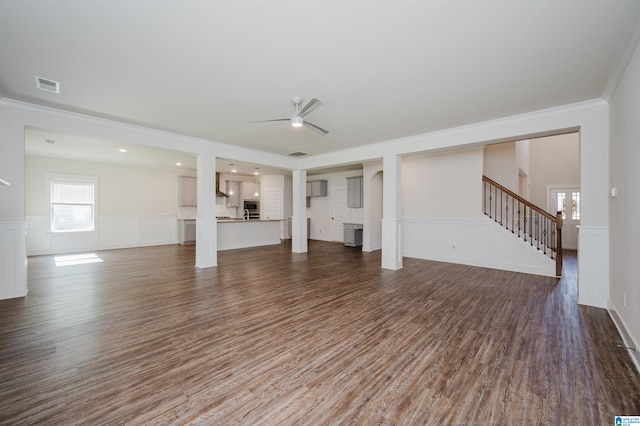 unfurnished living room with hardwood / wood-style floors, ceiling fan, and ornamental molding