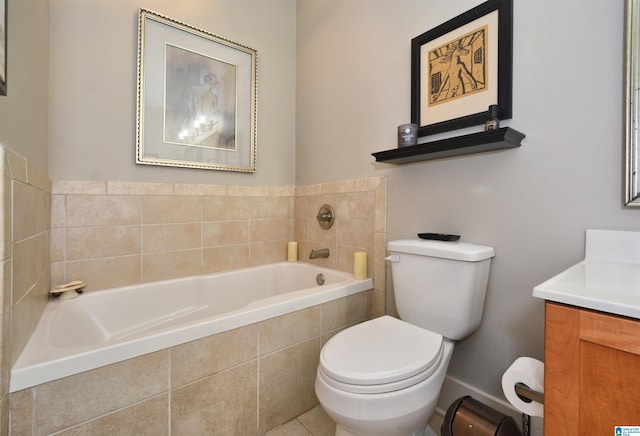 bathroom featuring tiled bath, vanity, tile patterned floors, and toilet