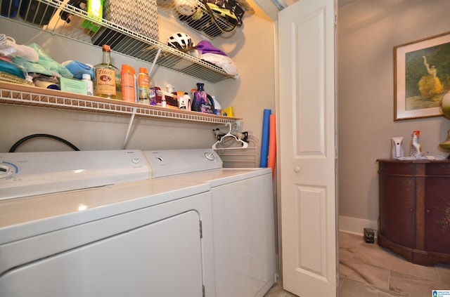 clothes washing area with washer and clothes dryer and light tile patterned floors