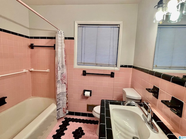 full bathroom featuring sink, tile walls, and toilet