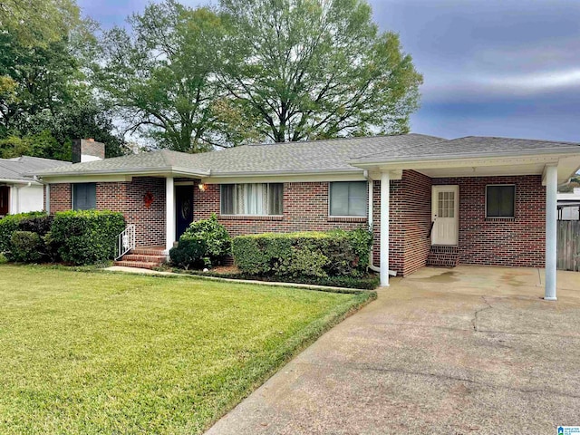 ranch-style home with a lawn