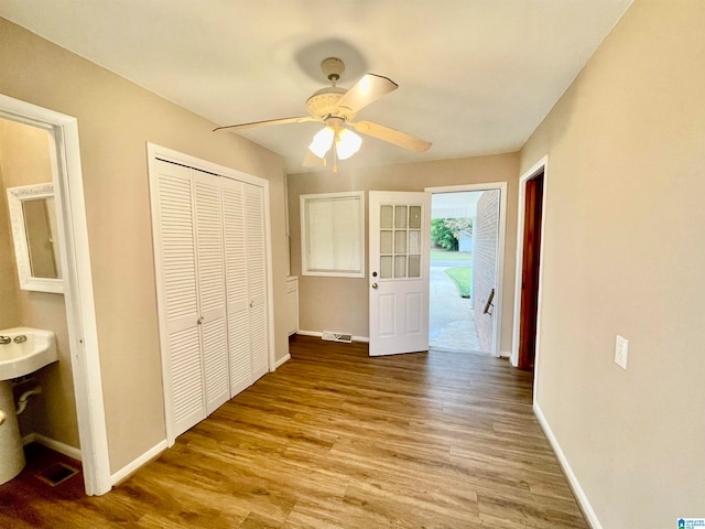 interior space with a closet, light wood-type flooring, and ceiling fan