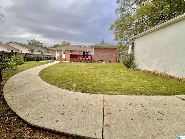 back of house with a lawn