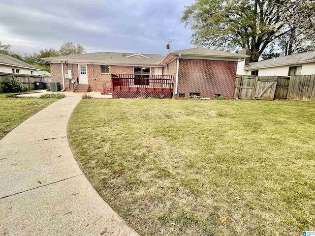 exterior space featuring central AC unit, a wooden deck, and a front yard