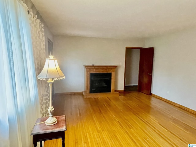 unfurnished living room featuring hardwood / wood-style flooring