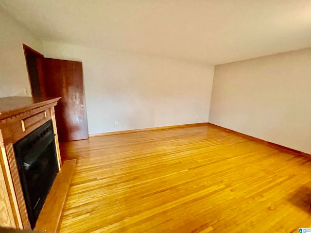 unfurnished living room featuring hardwood / wood-style flooring