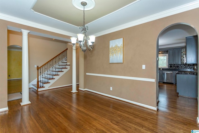 interior space featuring dark wood-type flooring, a notable chandelier, and crown molding