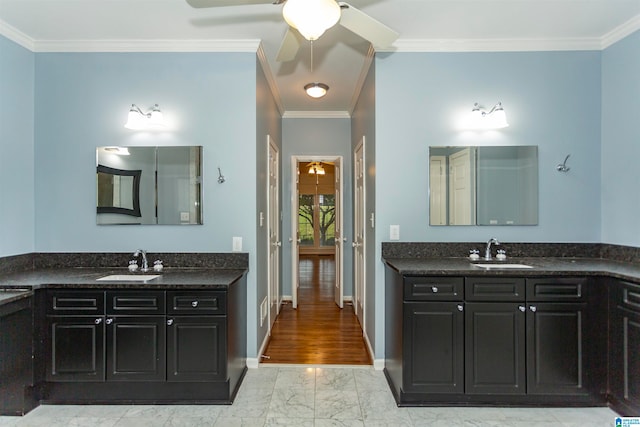 bathroom featuring ornamental molding, vanity, and ceiling fan