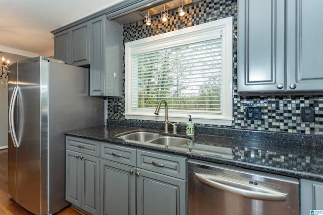 kitchen featuring crown molding, stainless steel appliances, decorative backsplash, hardwood / wood-style floors, and sink