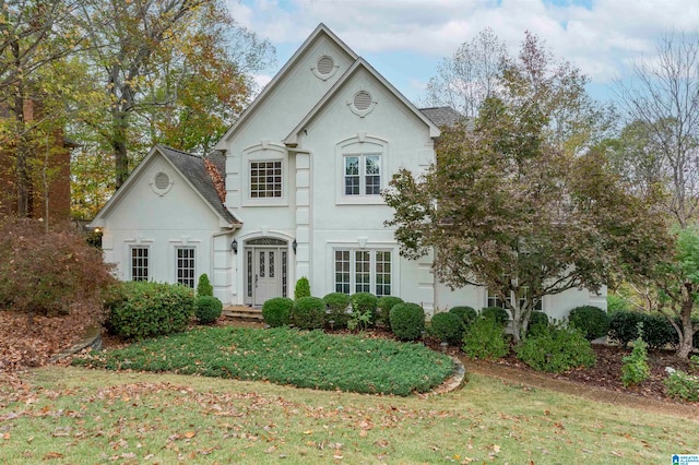 french country style house featuring a front yard