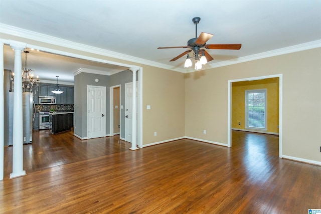 unfurnished room featuring ceiling fan with notable chandelier, dark wood-type flooring, crown molding, and decorative columns