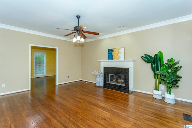 unfurnished living room with hardwood / wood-style floors, ceiling fan, and crown molding