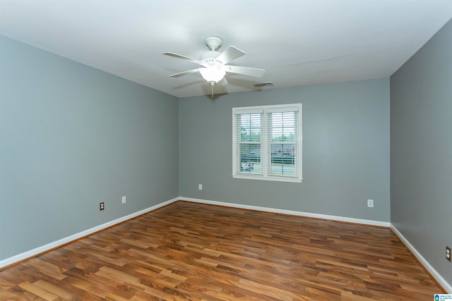 unfurnished room featuring dark hardwood / wood-style flooring and ceiling fan