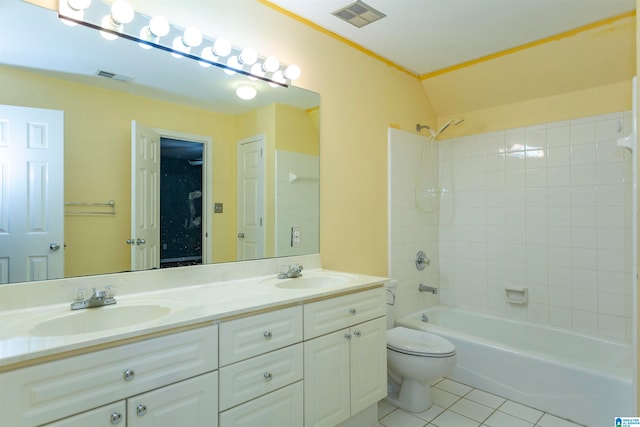 full bathroom with tile patterned floors, vanity, tiled shower / bath, toilet, and lofted ceiling