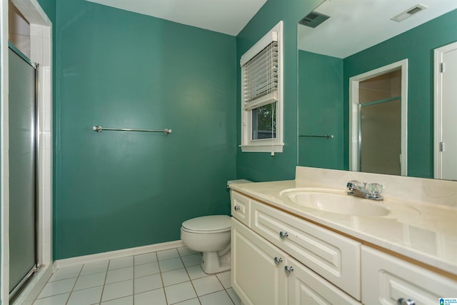 bathroom with a shower with shower door, tile patterned floors, and toilet