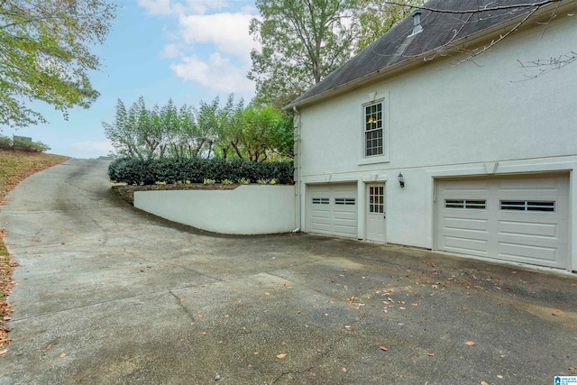 view of side of home featuring a garage