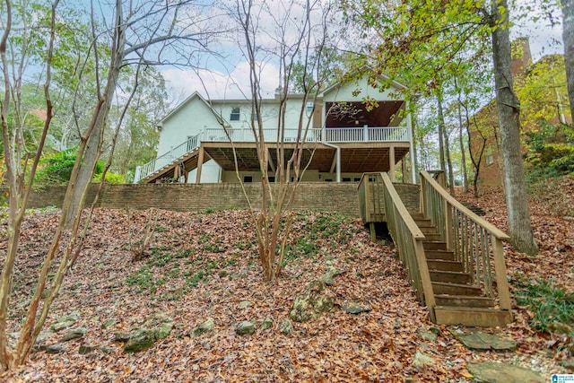 back of property featuring a wooden deck