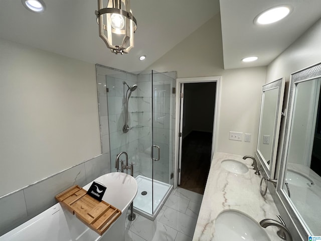 bathroom with vanity, lofted ceiling, and shower with separate bathtub