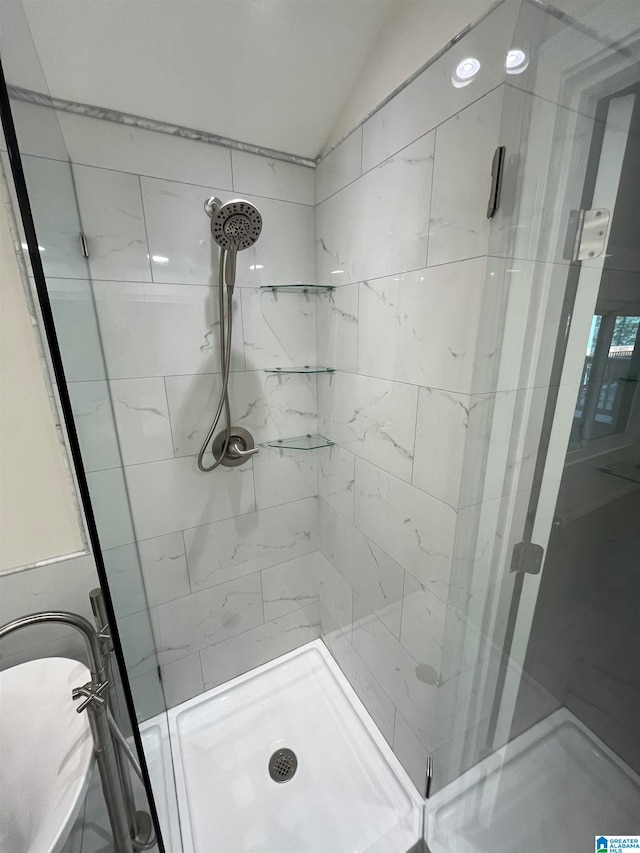 bathroom with a shower with shower door