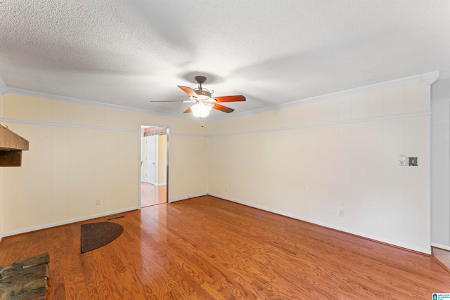 spare room with ceiling fan, hardwood / wood-style floors, crown molding, and a textured ceiling