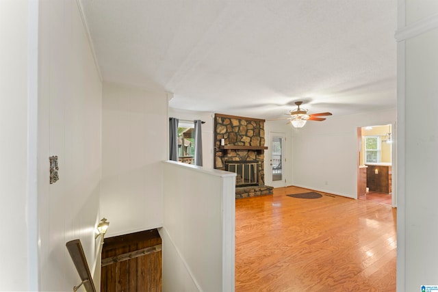 living room featuring a fireplace, hardwood / wood-style floors, and ceiling fan