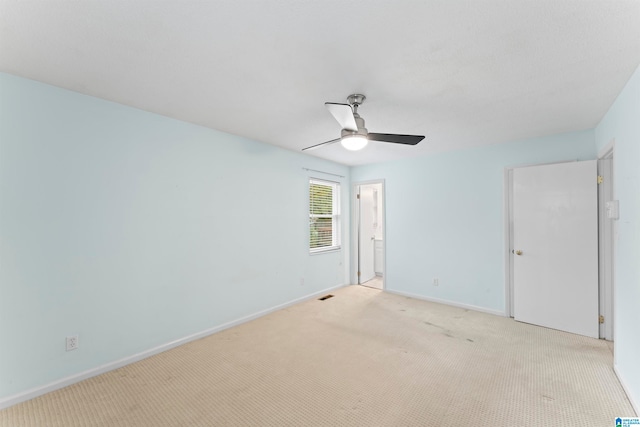 spare room with light carpet and ceiling fan