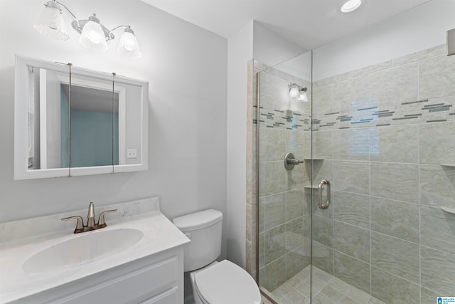 bathroom with vanity, an enclosed shower, and toilet