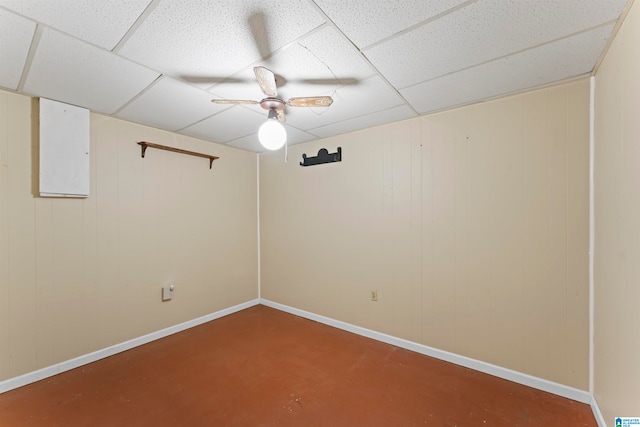 spare room featuring concrete floors, a drop ceiling, and ceiling fan