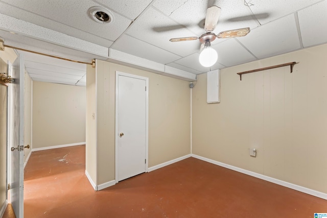 basement with a drop ceiling and ceiling fan