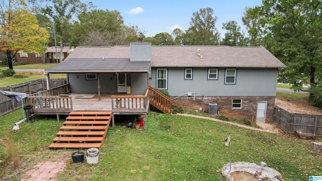 rear view of house featuring central AC unit, a yard, and a deck