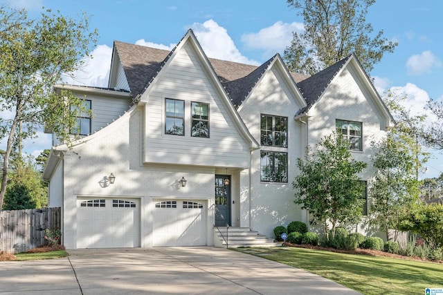 view of front of property featuring a garage and a front yard