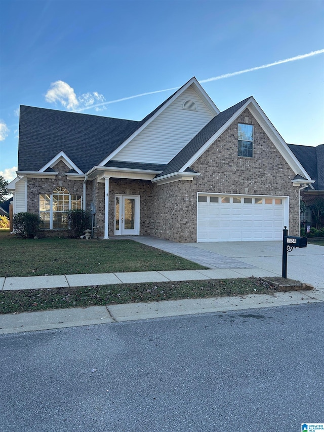 view of front of home featuring a front yard and a garage