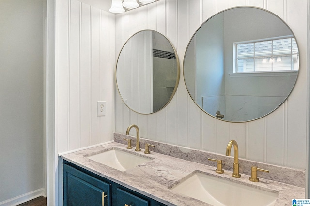 bathroom featuring vanity and wooden walls