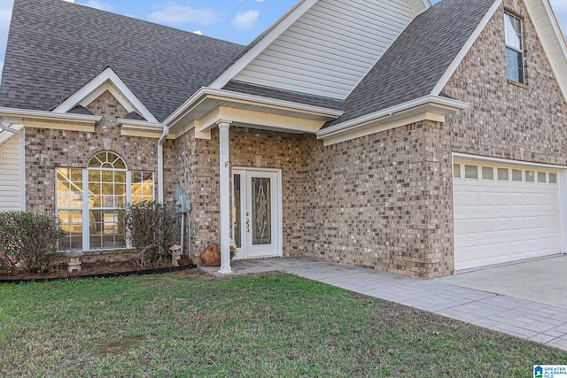 view of front of property with a front yard and a garage