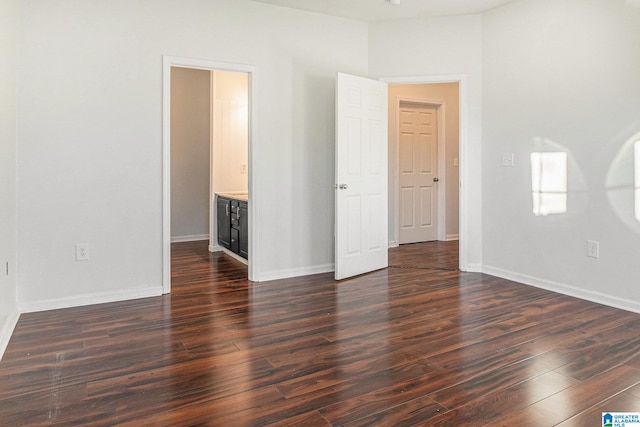 unfurnished room featuring dark wood-type flooring