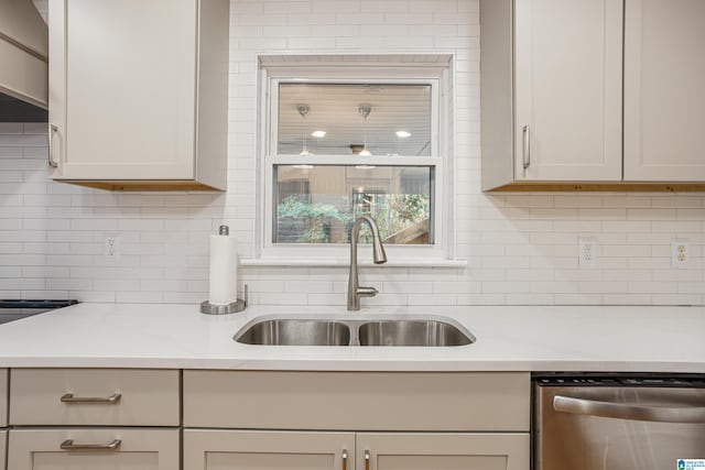 kitchen with white range oven, backsplash, light stone countertops, sink, and dishwasher