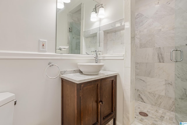 bathroom featuring vanity, toilet, and an enclosed shower