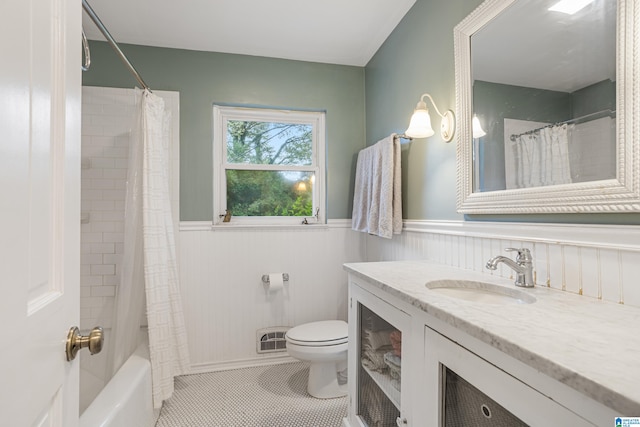 full bathroom featuring shower / tub combo with curtain, vanity, toilet, and tile patterned floors