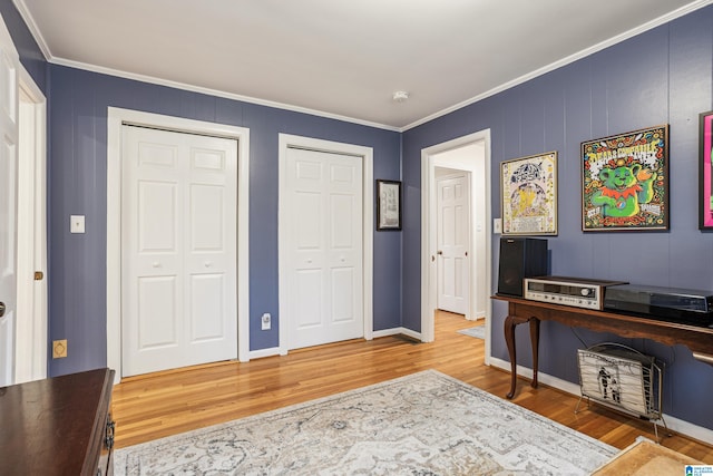 interior space featuring wood-type flooring and ornamental molding