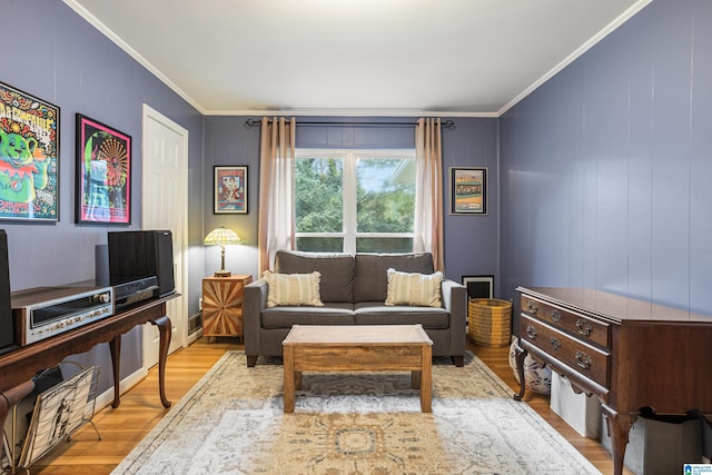 sitting room with light hardwood / wood-style floors and crown molding