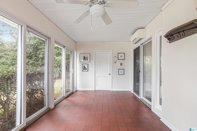 unfurnished sunroom with a wall unit AC and ceiling fan