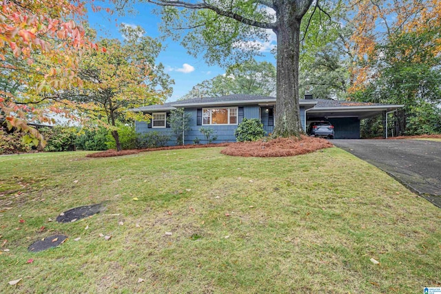 ranch-style house with a front yard and a carport