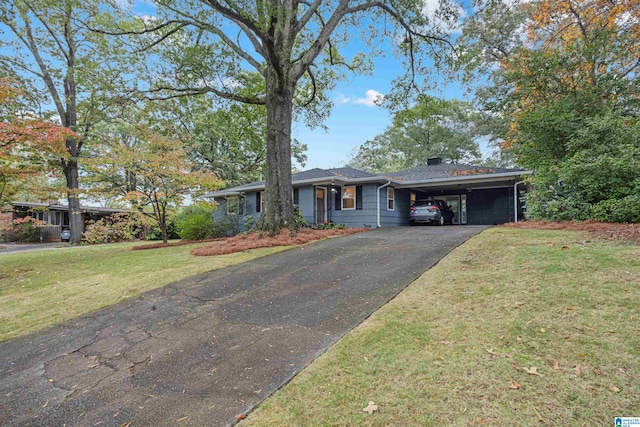 ranch-style house featuring a front yard and a carport