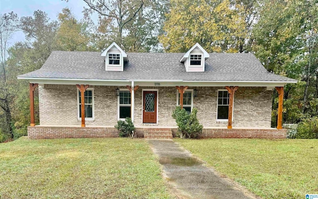 cape cod-style house with a porch and a front yard