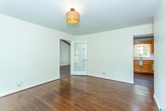 unfurnished room with dark hardwood / wood-style floors and sink