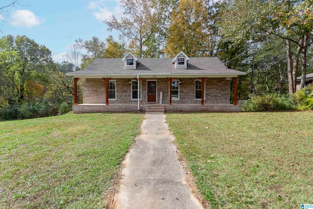 new england style home featuring covered porch and a front lawn