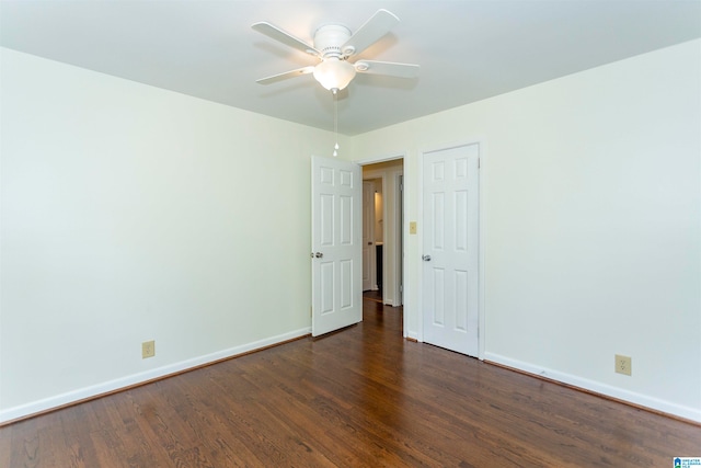 spare room with dark wood-type flooring and ceiling fan